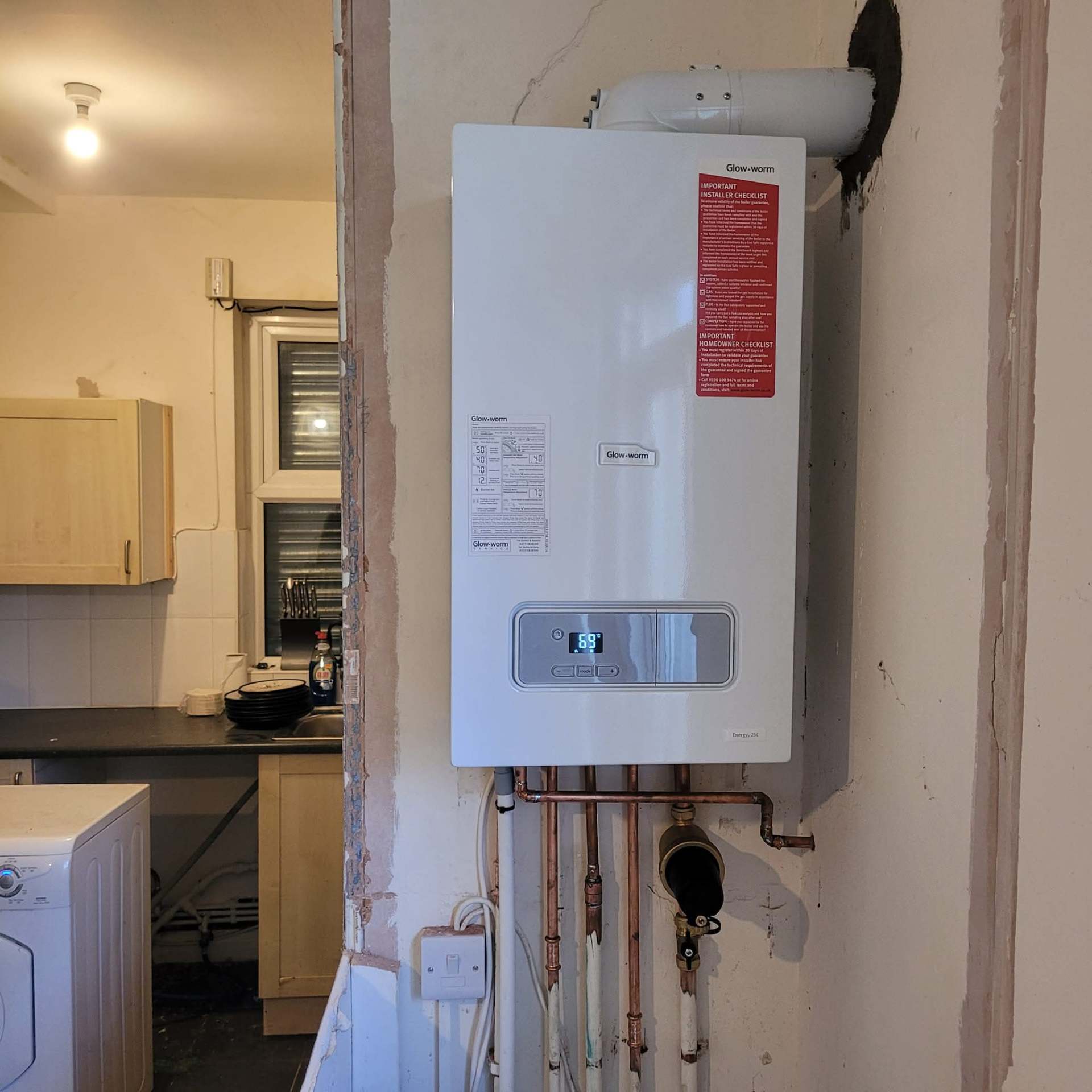 Hot water cylinder installation with branded installer label