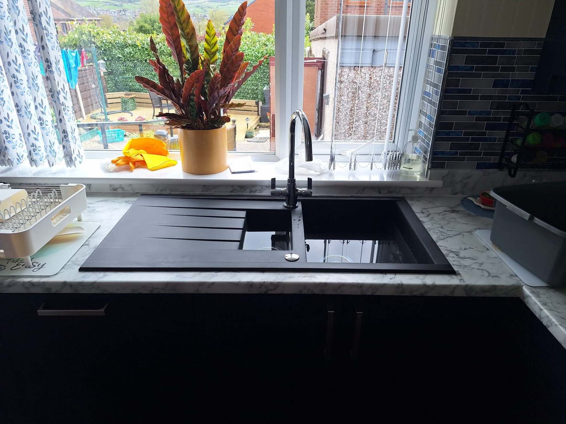 New kitchen sink with monobloc mixer tap and waste plumbing installed in a Greater Manchester home
